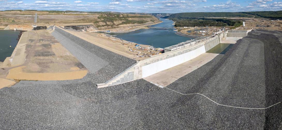 The reservoir will rise midway up the rip rap on the upstream face of the dam, and it will flow into the approach channel to the right. | August 2024