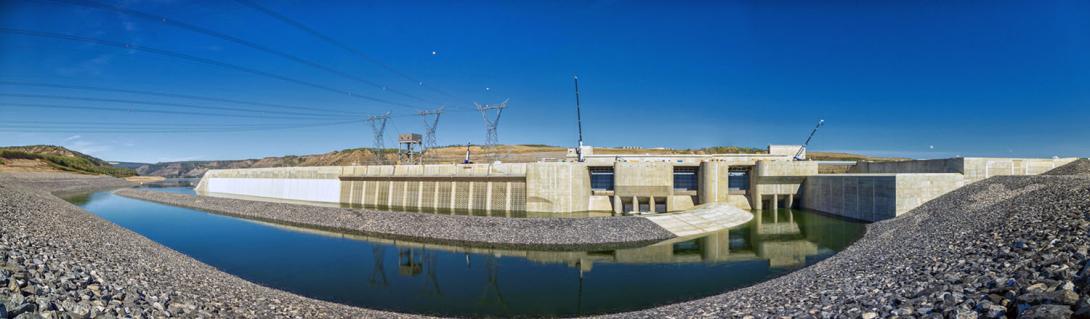 On the upstream side of the dam, water will flow through the intake gates and into the powerhouse to generate electricity. During reservoir filling, water is passing through the lower-level outlet gates. | September 2024