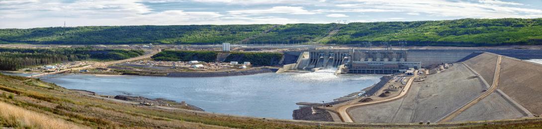 The downstream side of the dam is where the Peace River begins. During reservoir filling, water is flowing through the lower- level outlet gates to maintain downstream flows. | September 2024