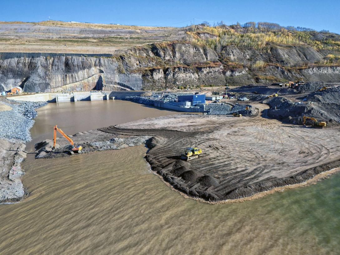 Coffer dam construction nears completion at the diversion outlet portal. | September 2024