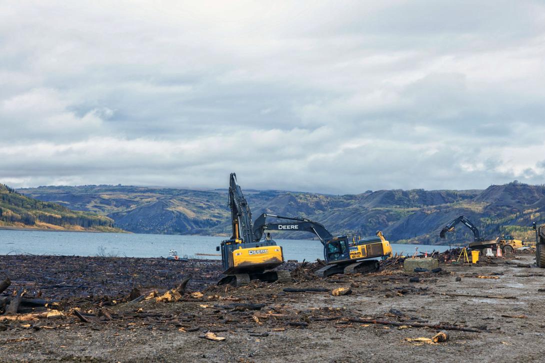 Wood debris released from the cleared river area is collected downstream at the damsite where it is removed and stockpiled for future use. | September 2024