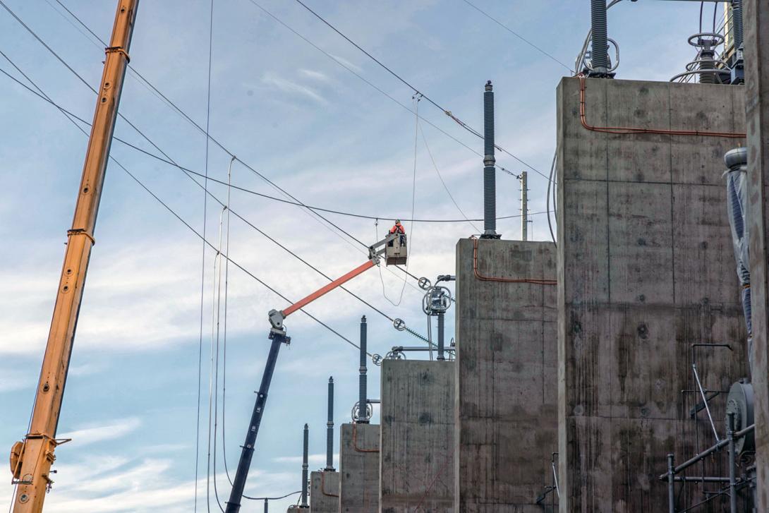 Crews work to connect transmission tower two to the transformer. 