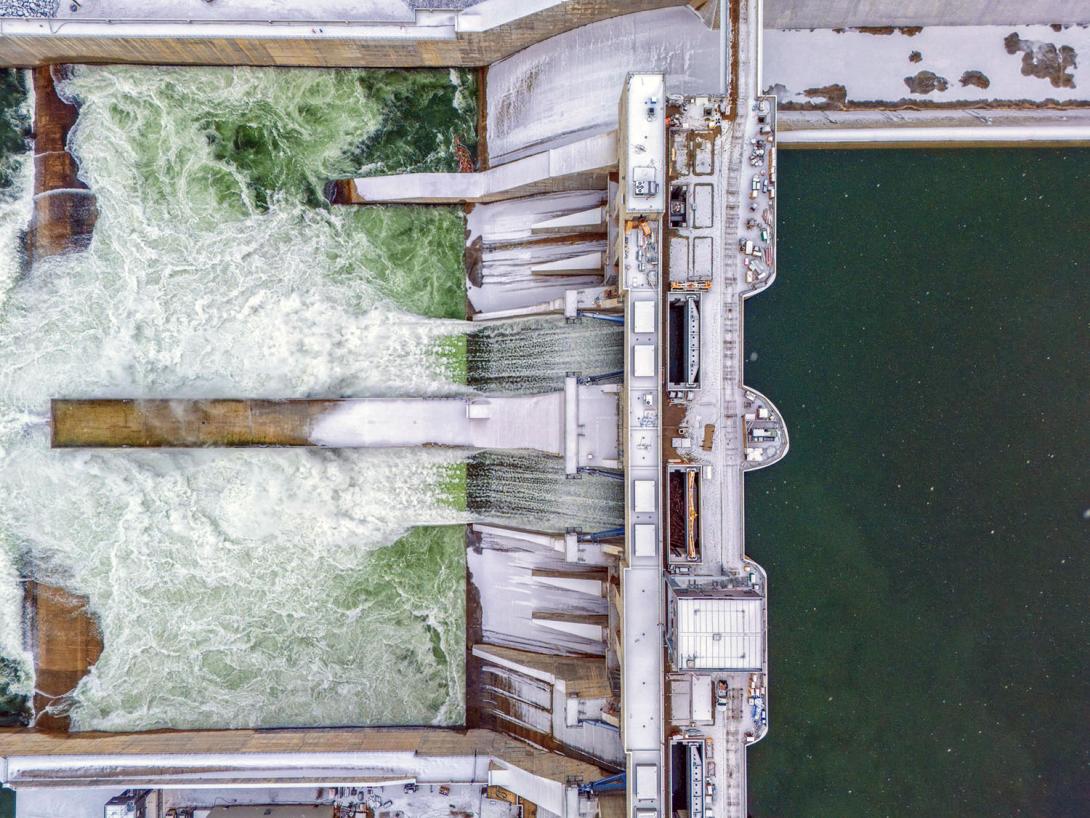 A top view of the intake deck with water flowing from the approach channel through the spillways into the Peace River. | November 2024