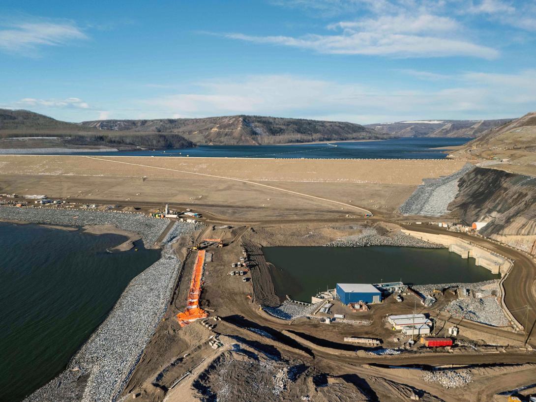 The coffer dam in front of the diversion outlet portals will provide a dry area to allow backfilling of the diversion tunnels. The slurry wall is a water barrier; the orange tarps protect the wall from freezing as it cures.