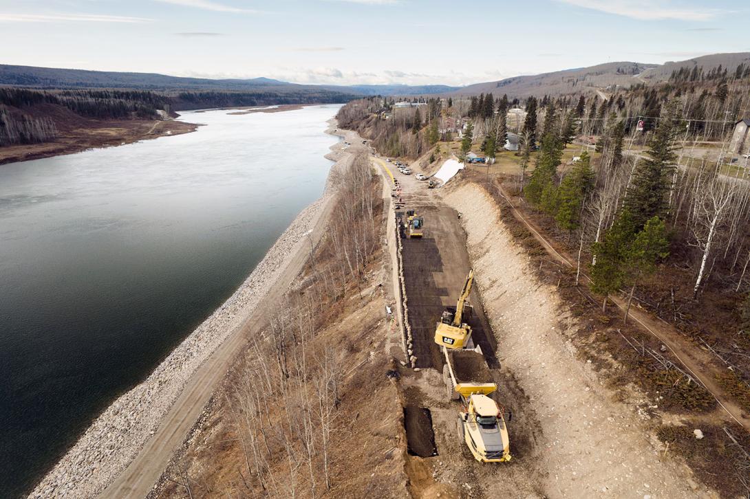 An excavator and rock truck place backfill on the D.A. Thomas Road in Hudson’s Hope.