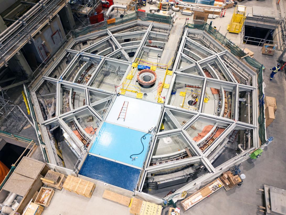 Workers are installing floor panels on the top braces of turbine unit 5. 