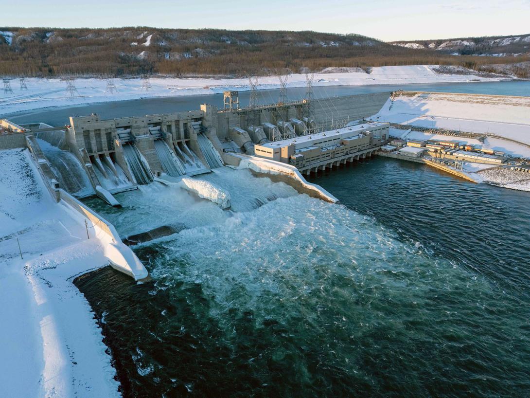 Ice forms on the stilling basin walls as water flows downstream through the spillways. | January 2025