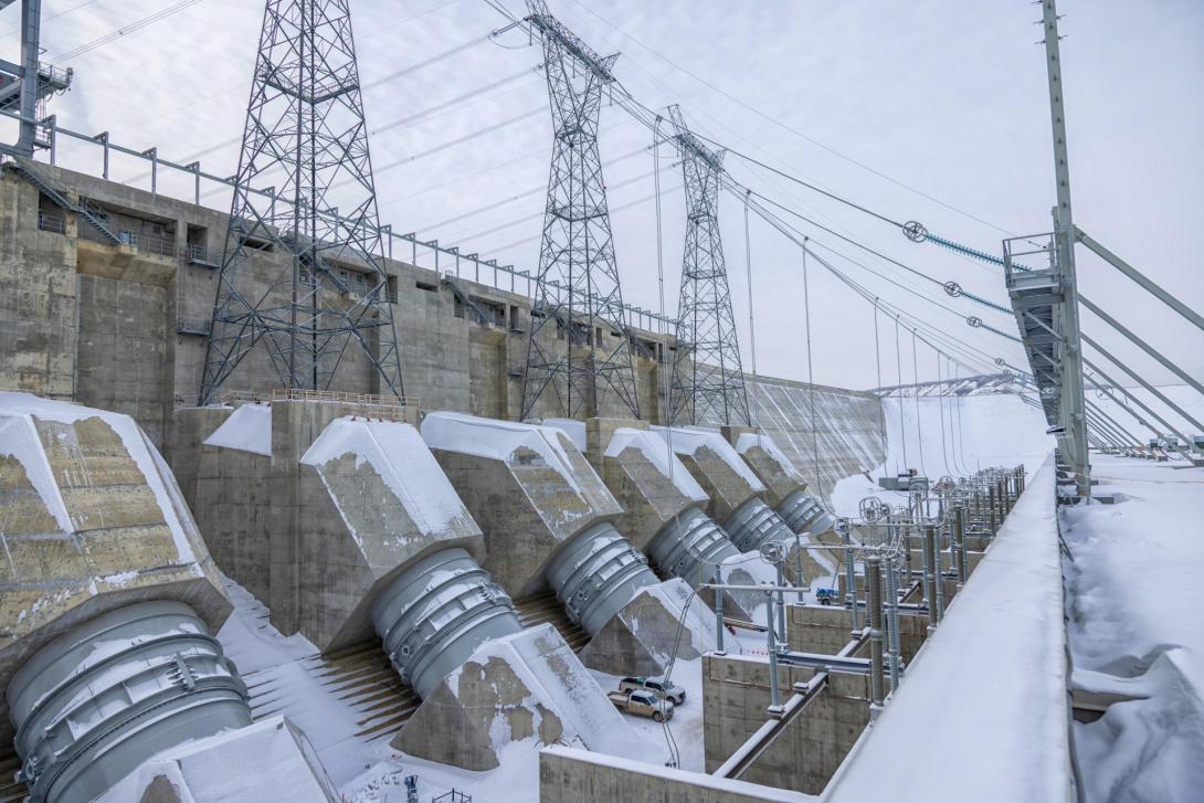 Water is flowing from penstock units 1 and 2 into turbine units 1 and 2. Power is travelling into the BC Hydro electricity grid through the first transmission tower. A third turbine unit came online on February 24. | February 2025